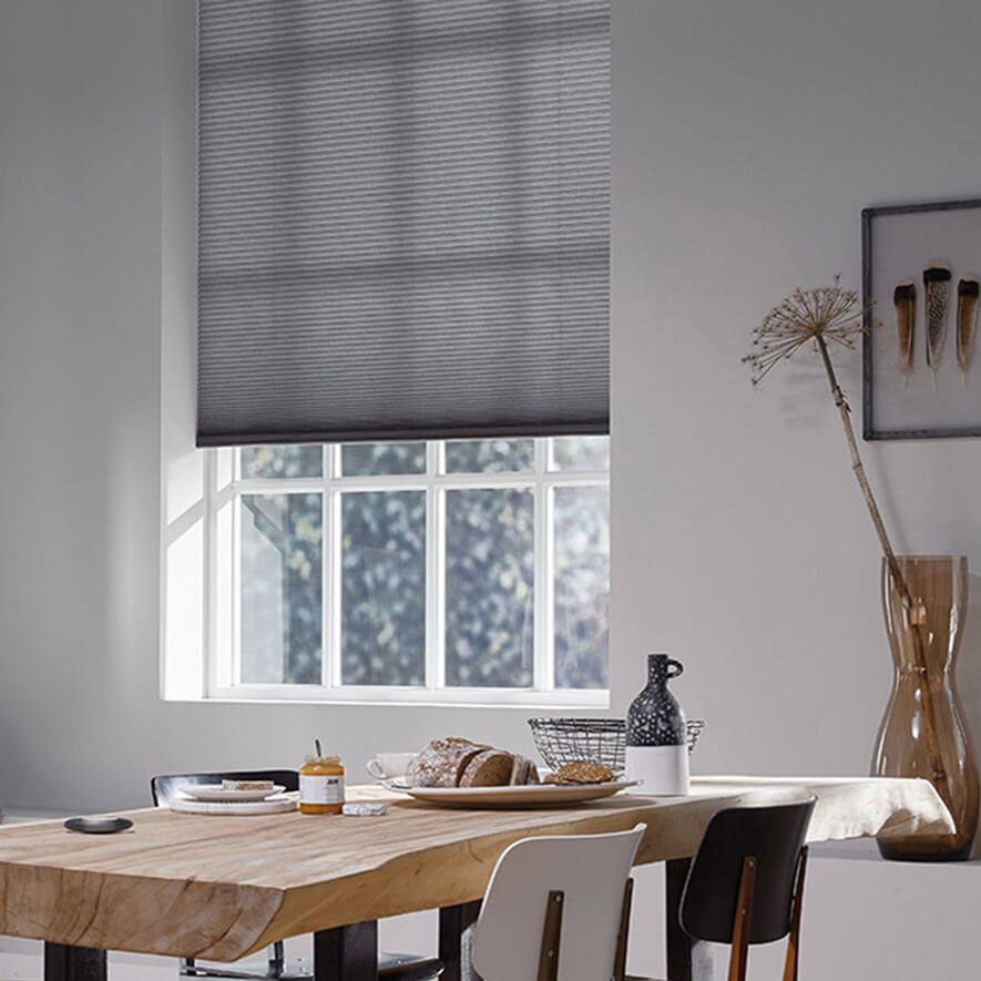 Graues Plisseerollo im Wohnzimmer